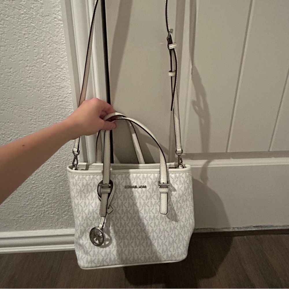 White Michael Kors, Has shoulder straps and a cross body strap.